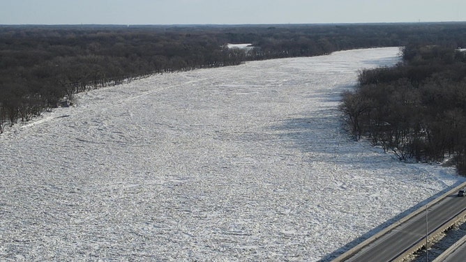 Solid ice remained in place Monday over much of the Kankakee River.