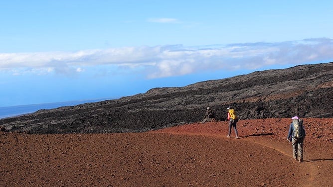 FILE: Hikers descend Mauna Loa Trail from Mauna Loa Trail from Pu‘u ‘Ula‘ula.