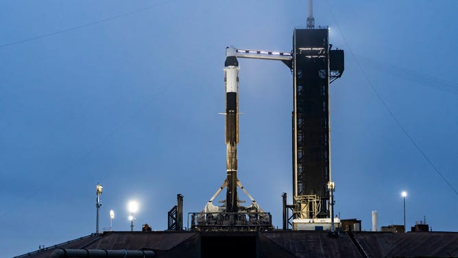 A SpaceX Crew Dragon capsule stands on top of the Falcon 9 rocket at Kennedy Space Center's launchpad 39A ahead of the Ax-3 mission.