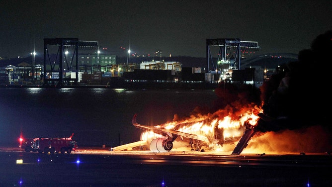 This photo provided by Jiji Press shows a Japan Airlines plane on fire on a runway of Tokyo's Haneda Airport on January 2, 2024. A Japan Airlines plane was in flames on the runway of Tokyo's Haneda Airport on January 2 after apparently colliding with a coast guard aircraft, television reports said. (Photo by JIJI PRESS / AFP) / Japan OUT (Photo by STR/JIJI PRESS/AFP via Getty Images)