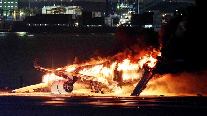 TOPSHOT - This photo provided by Jiji Press shows a Japan Airlines plane on fire on a runway of Tokyo's Haneda Airport on January 2, 2024. A Japan Airlines plane was in flames on the runway of Tokyo's Haneda Airport on January 2 after apparently colliding with a coast guard aircraft, television reports said. (Photo by JIJI PRESS / AFP) / Japan OUT (Photo by STR/JIJI PRESS/AFP via Getty Images)