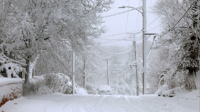 Snow covers a street as a snowstorm dumps several inches of snow on the area on January 09, 2024 in Des Moines, Iowa.