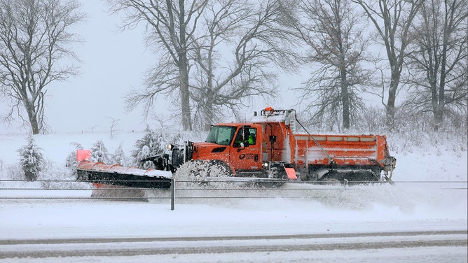 A plow clears I-80 as a snowstorm dumps several inches of snow on the area on January 09, 2024 in Des Moines, Iowa.