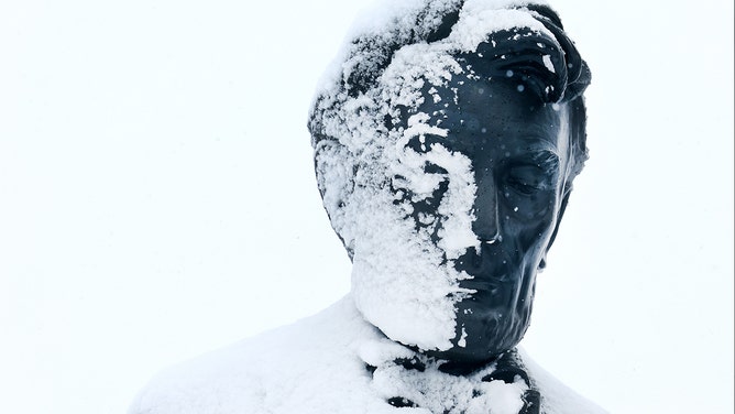 Snow covers half the face of former U.S. president Abraham Lincoln's statue at the Iowa State Capitol building on January 09, 2024 in Des Moines, Iowa.