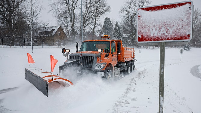 Plow trucks work to clear the Interstate 235 John MacVicar Freeway Freeway as winter storm Gerri dumps inches of snow with high winds on January 12, 2024 in Des Moines, Iowa.