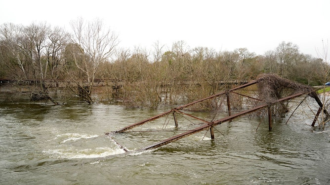 A historic metal truss bridge along FM 2854 known as the Bonnie and Clyde Bridge is shown Thursday, Jan. 25, 2024, in Conroe. It collapsed into the San Jacinto River from floodwaters.