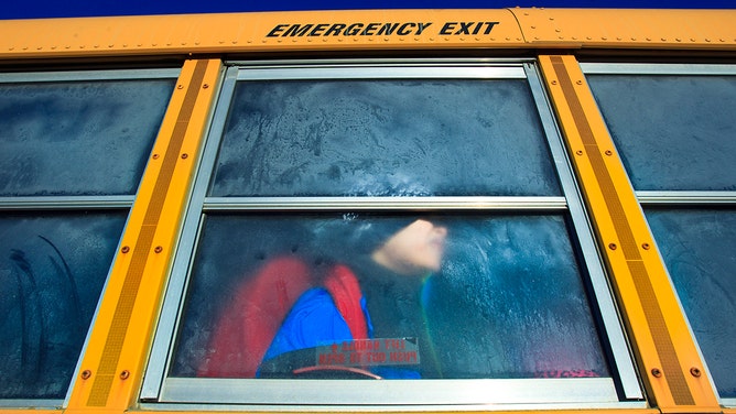 FILE – Jacob Violette, a student at Hilltop Elementary School in Caribou, Maine, strained to see out of a frosted bus window on his way home from school.