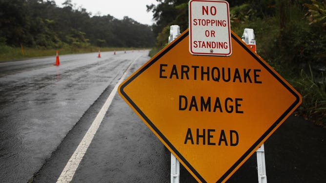 HAWAII VOLCANOES NATIONAL PARK, HI - MAY 17: A sign is posted warning of earthquake damage to the road from seismic activity at the Kilauea volcano on Hawaii's Big Island on May 17, 2018 in Hawaii Volcanoes National Park, Hawaii. The U.S. Geological Survey said the volcano erupted explosively in the early morning hours today launching a plume about 30,000 feet into the sky. (Photo by Mario Tama/Getty Images)