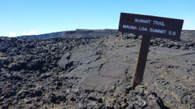 Sign noting the distance to the summit of Mauna Loa.