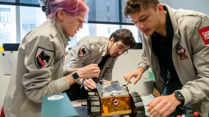 Members of the Iris team work on assembling an earlier model of the Iris rover for the afternoon demo during Iris Rover Media Day in the Mission Control Room of Gates on Tuesday, April 4, 2023.