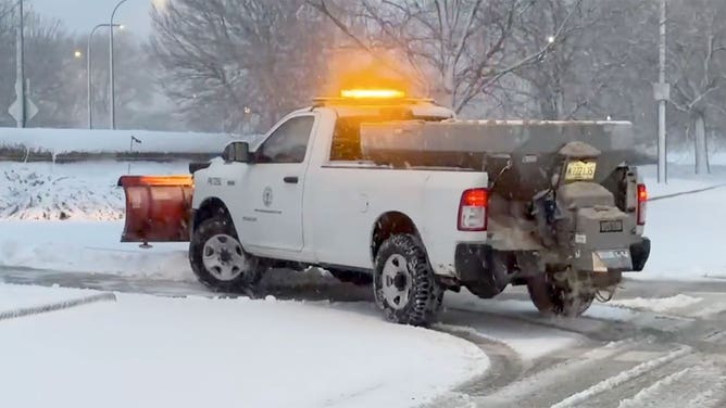 A truck works to plow streets in Chicago, Illinois, during a winter storm Jan. 12, 2024.