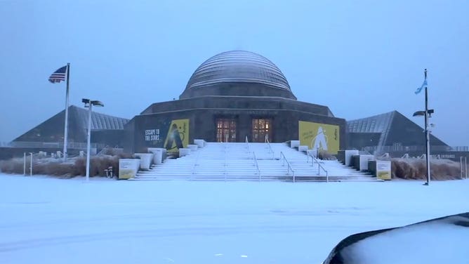 Snow covers the ground outside the Adler Planetarium in Chicago, Illinois, during a winter storm Jan. 12, 2024.