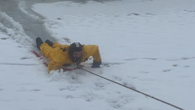 A North Davis Fire District firefighters rescues a dog from a frozen pond in West Point, Utah on Jan. 14, 2024.
