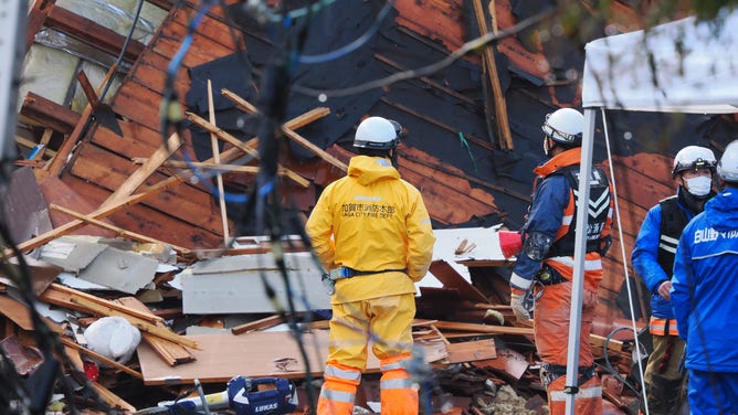 Rescuers search for missing victims at a landslide site in the Kawashima district in the city of Anamizu, Ishikawa Prefecture, on January 6, 2024, after a major 7.5 magnitude earthquake struck the Noto region on New Year's Day. Rescuers sifted through rubble on January 6 as focus turned to recovering bodies rather than finding survivors five days after a huge earthquake struck central Japan, with 98 people now confirmed killed. (Photo by Toshifumi KITAMURA / AFP)