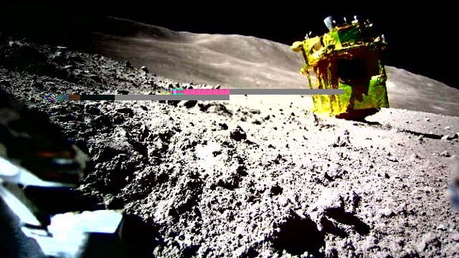 A phot from the probe Lev-2 shows the SLIM lander on its nose on the lunar surface.