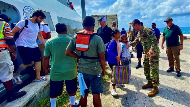 U.S. Army Garrison – Kwajalein Atoll Commander Col. Drew Morgan, center right, welcomes Roi-Namur evacuees to Kwajalein Island on Jan. 21. Roi-Namur is a four-hour boat trip from Kwajalein.