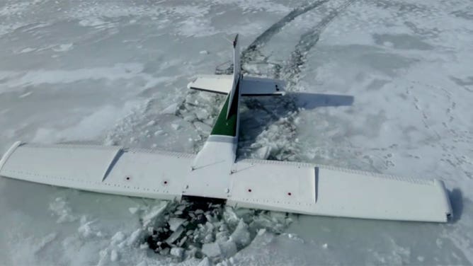 A small plane is seen in an icy Pineview Reservoir in Huntsville, Utah, after a crash on Jan. 26, 2024.