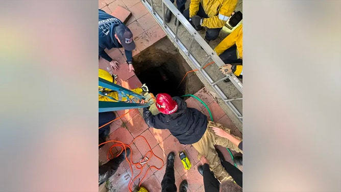 Rescue crews with the San Bernardino County Fire Department were working to rescue a woman who became trapped in a massive sinkhole on Thursday, Feb. 8, 2024.