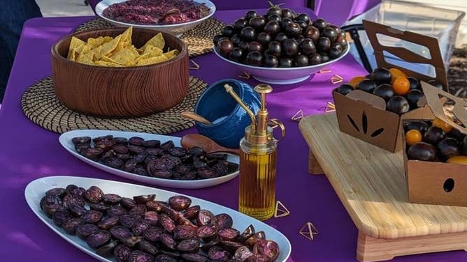 A spread with purple tomatoes.