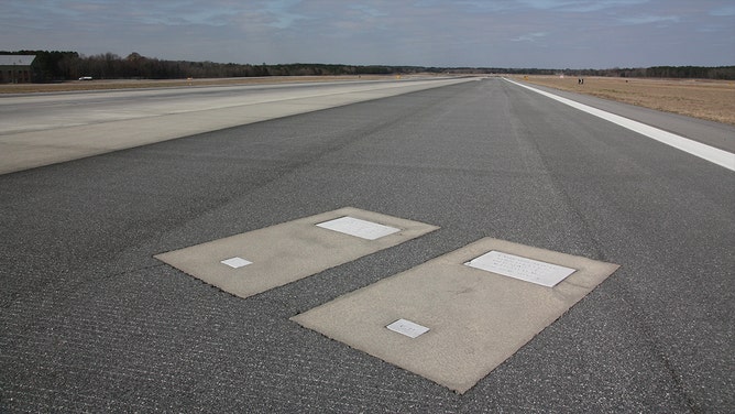 Richard and Catherine Dotson's gravestones are located on Runway 10, the airport's most active runway.