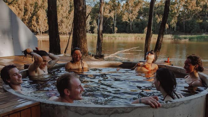 People soak in a tub at a sister festival.