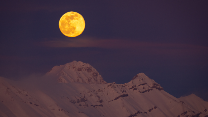Snow moon rises behind Corno Grande and Pizzo Cefalone peaks (Gran Sasso dItalia National Park) in LAquila, Abruzzo (Italy), on february 5, 2023. February full moon is usually called snow moon. (Photo by Lorenzo Di Cola/NurPhoto via Getty Images)