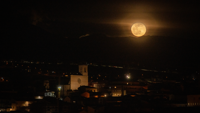 Snow moon rises above San Silvestro bell tower church in LAquila, Abruzzo (Italy), on february 6, 2023. February full moon is usually called snow moon and is the smallest moon of the year (on february 4th moon reached its apogee). (Photo by Lorenzo Di Cola/NurPhoto via Getty Images)