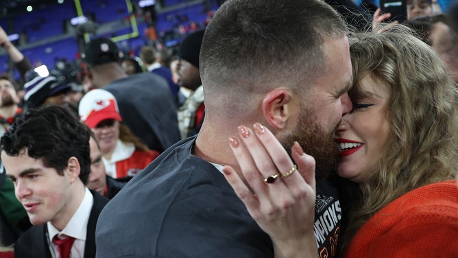 Travis Kelce of the Kansas City Chiefs embraces Taylor Swift after a 17-10 victory against the Baltimore Ravens in the AFC Championship Game at M&amp;T Bank Stadium on January 28, 2024 in Baltimore, Maryland.