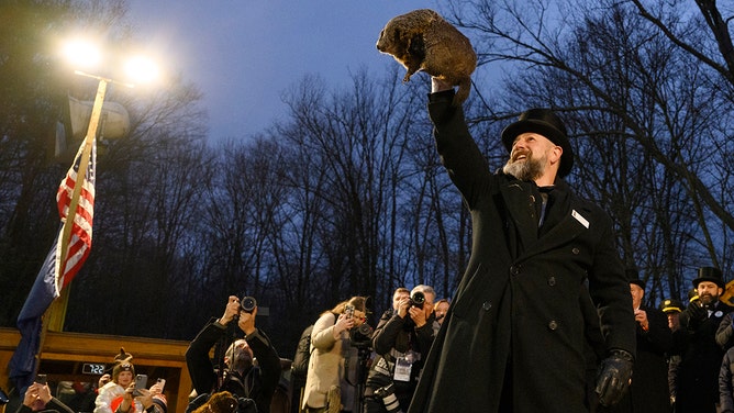 Groundhog handler AJ Dereume holds Punxsutawney Phil after he did not see his shadow predicting an early Spring during the 138th annual Groundhog Day festivities on Friday February 2, 2024 in Punxsutawney, Pennsylvania.