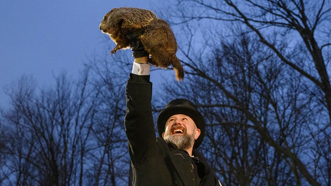 Groundhog handler AJ Dereume holds Punxsutawney Phil after he did not see his shadow predicting an early Spring during the 138th annual Groundhog Day festivities on Friday February 2, 2024 in Punxsutawney, Pennsylvania.