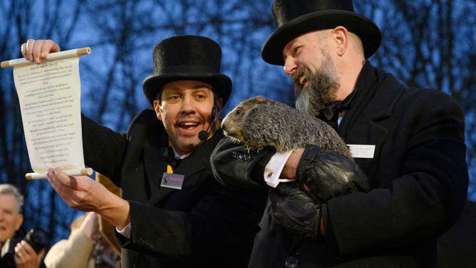 Groundhog Day Inner Circle Vice President Dan McGinley announces the weather prognostication as groundhog handler AJ Dereume holds Punxsutawney Phil after he did not see his shadow predicting an early Spring during the 138th annual Groundhog Day festivities on Friday February 2, 2024 in Punxsutawney, Pennsylvania.