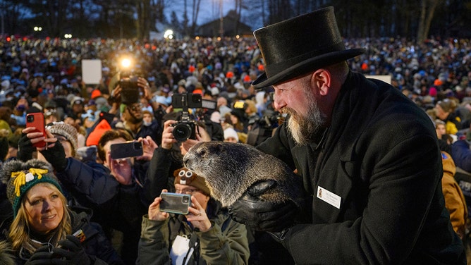 Groundhog handler AJ Dereume holds Punxsutawney Phil after he did not see his shadow predicting an early Spring during the 138th annual Groundhog Day festivities on Friday February 2, 2024 in Punxsutawney, Pennsylvania.