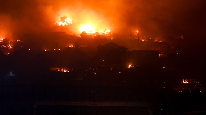 Houses burn due to a forest fire during night time in Valparaiso, Chile on Friday, Feb. 2,2024.