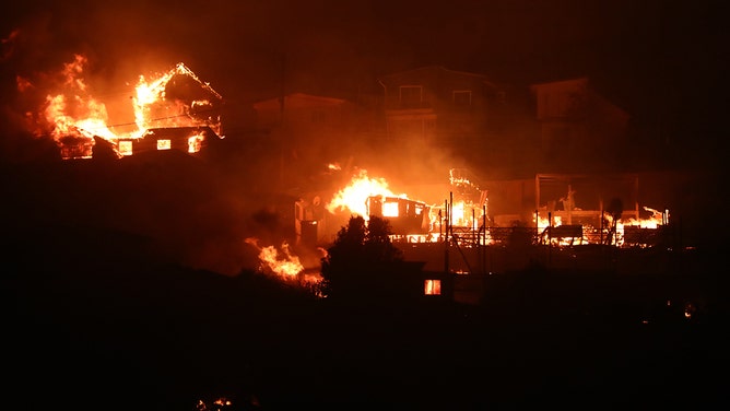 Houses burn due to a forest fire during night time in Valparaiso, Chile on Friday, Feb. 2,2024.