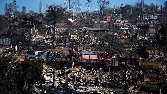 A fire truck is seen amongst burnt houses after a fire that affected the hills in Viña del Mar, Chile on February 3, 2024.