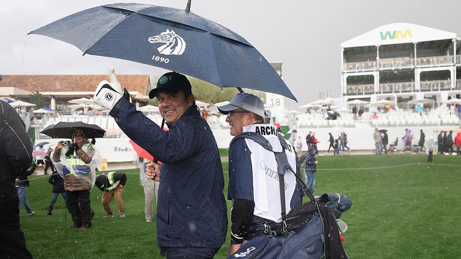Scott Archibald reacts as he walks off the 18th hole during a weather delay atthe Pro-am to the WM Phoenix Open at TPC Scottsdale on February 07, 2024 in Scottsdale, Arizona.