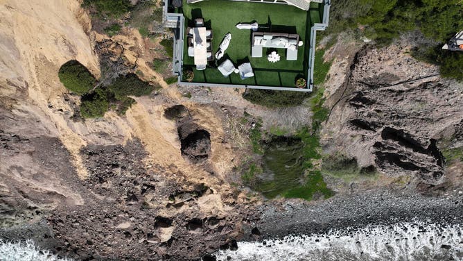 Aerial view of three large homes in Dana Point that are in danger of falling into the ocean after a cliffside gave way over the weekend.