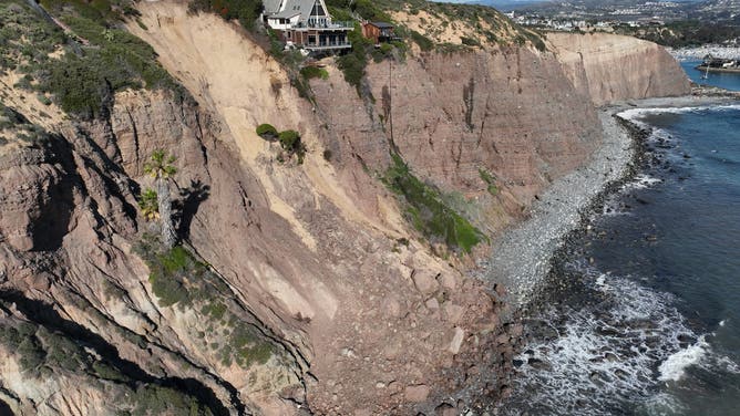 Aerial view of three large homes in Dana Point that are in danger of falling into the ocean after a cliffside gave way over the weekend.