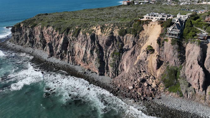 Aerial view of three large homes in Dana Point that are in danger of falling into the ocean after a cliffside gave way over the weekend.