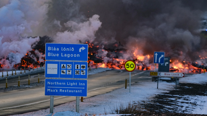 Molten lava is seen overflowing the road leading to the famous tourist destination "Blue Lagoon" near Grindavik, western Iceland on February 8, 2023. A volcanic eruption started on the Reykjanes peninsula in southwestern Iceland on Thursday, the third to hit the area since December, authorities said. (Photo by Kristinn Magnusson / AFP) / Iceland OUT (Photo by KRISTINN MAGNUSSON/AFP via Getty Images)