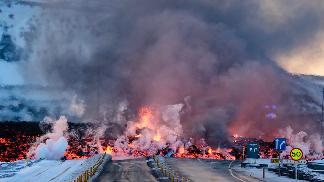 Molten lava is seen overflowing the road leading to the famous tourist destination "Blue Lagoon" near Grindavik, western Iceland on February 8, 2023. A volcanic eruption started on the Reykjanes peninsula in southwestern Iceland on Thursday, the third to hit the area since December, authorities said. (Photo by Kristinn Magnusson / AFP) / Iceland OUT (Photo by KRISTINN MAGNUSSON/AFP via Getty Images)