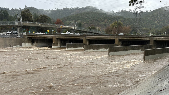 Water is seen rushing downstream in the Los Angeles area on Monday, Feb. 5, 2024.