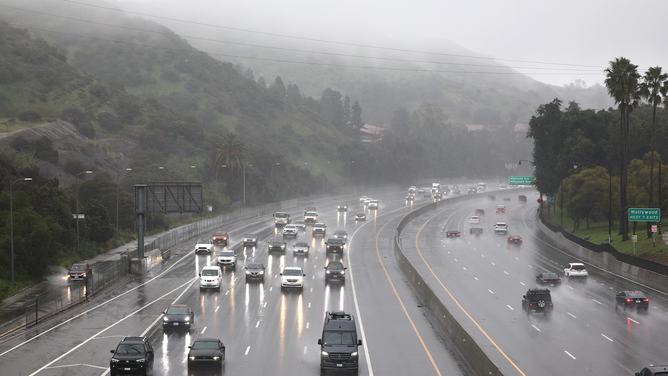 LOS ANGELES, CALIFORNIA - FEBRUARY 19: Vehicles drive through the rain on the 101 freeway on February 19, 2024 in Los Angeles, California. Another atmospheric river storm is delivering heavy rains to California two weeks after a powerful storm brought widespread flooding, mudslides and power outages to parts of the state. (Photo by Mario Tama/Getty Images)
