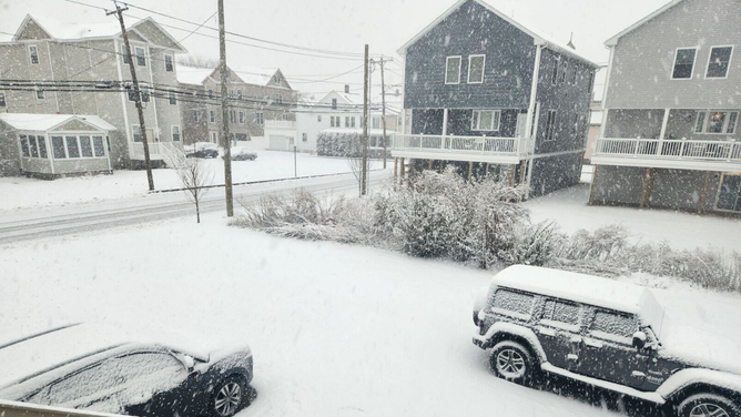 Heavy snow is seen covering vehicles and roads in Milford, Connecticut, during a noreaster on Tuesday, Feb. 13, 2024.