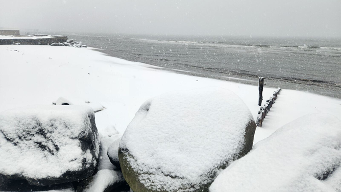 Heavy snow is seen falling over Long Island Sound in Milford, Connecticut, during a nor'easter on Tuesday, Feb. 13, 2024.