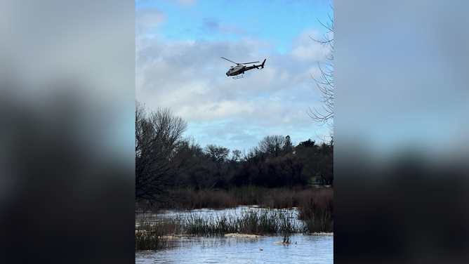 A photo showing a helicopter getting ready to rescue people from floodwaters in California on Monday, Feb. 19, 2024.