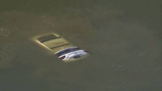 Before the firefighters arrived, a 16-year-old boy who lived in an apartment nearby dove in and swam to the vehicle. The driver was unconscious and didn't respond.