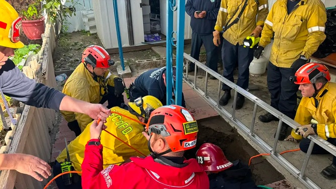 Rescue crews with the San Bernardino County Fire Department were working to rescue a woman who became trapped in a massive sinkhole on Thursday, Feb. 8, 2024.