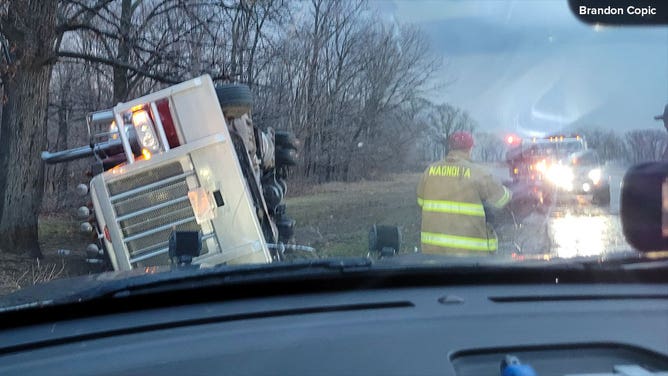 A tractor-trailer is flipped outside Henry, Illinois, after a severe storm on Feb. 8, 2024.