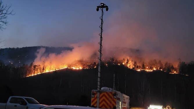 Photos show smoke and flames from the Peake Mountain and Bergton Fires in Rockingham County, Virginia on March 20, 2024.